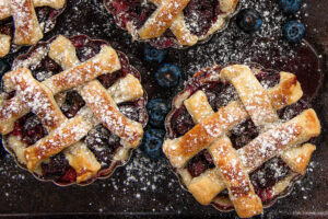 Baked Mini Blueberry Pies Sprinkled with Powedered Sugar