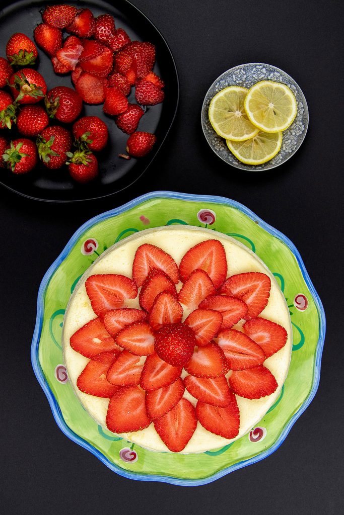 A cheesecake topped with strawberries.  
