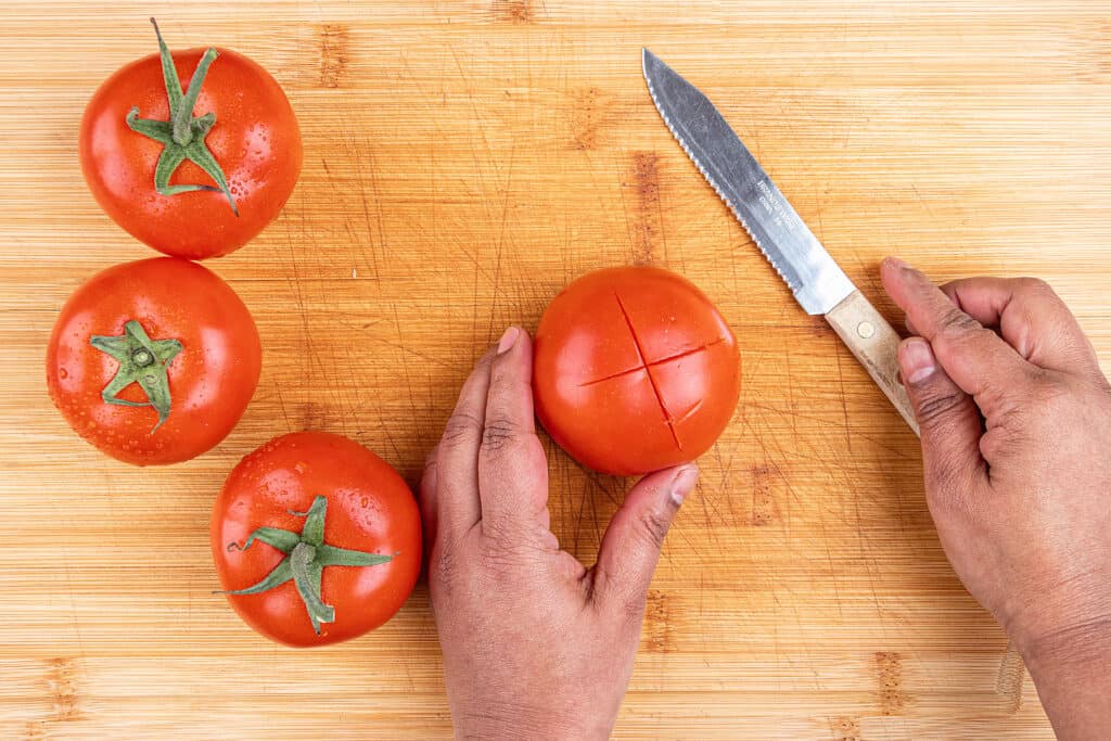 Step One - Cut an 'X' at the bottom of each tomato
