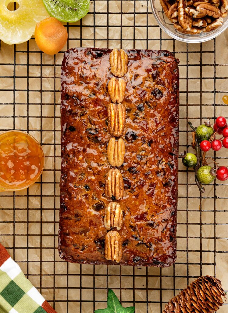 Fruit Cake with Rum brushed with an apricot glaze and decorated with pecans
