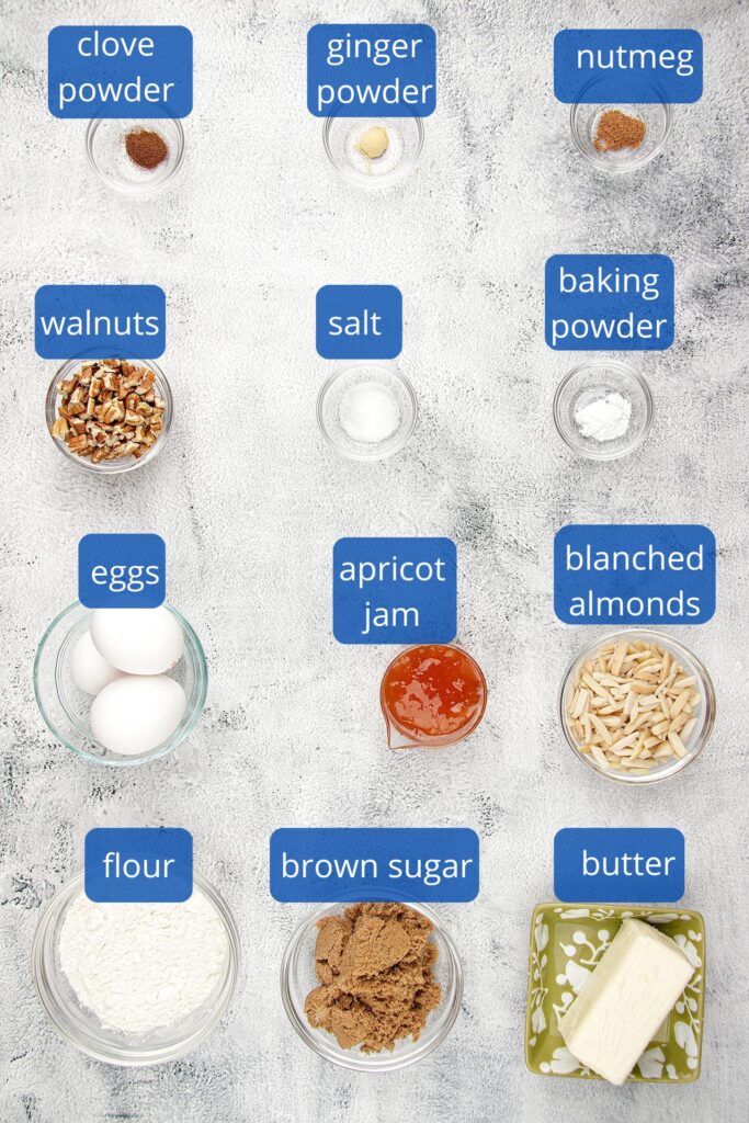 Ingredients for the fruit cake batter:  blanched, slivered almonds, unsalted butter, all-purpose flour, baking powder, salt, nutmeg, ginger powder, brown sugar, eggs and pecans.