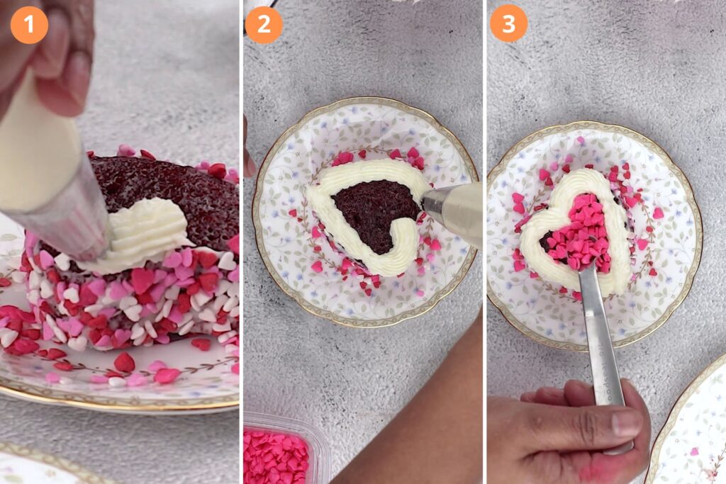 Decorate the mini red velvet cakes. Three step process (1) put sprinkles on the sides (2) pipe the heart on top (3) spoon in some sprinkles in the center of the heart